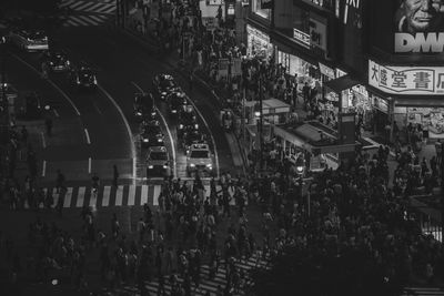 High angle view of people walking on street in city at night