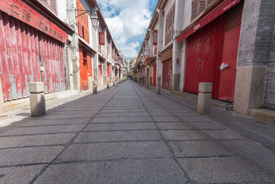 Empty alley amidst buildings in city