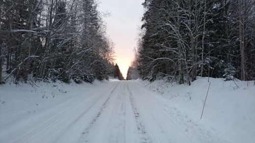 Snow covered landscape against sky