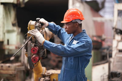 Side view of man working in workshop