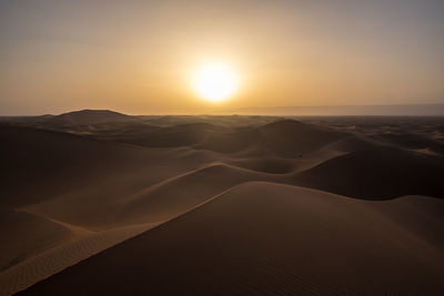 Erg chegaga, morocco - a sunset in the moroccan sahara desert, over an ocean of dunes.