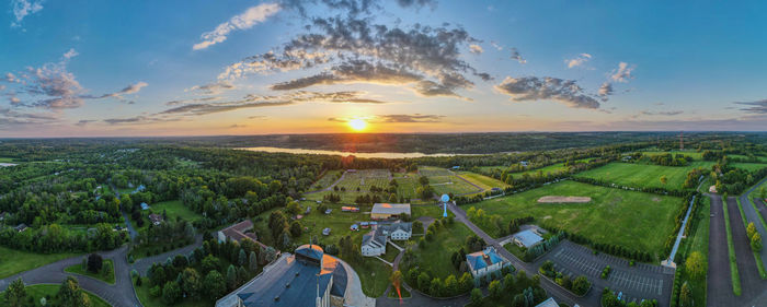 Panoramic view of agricultural field against sky during sunset