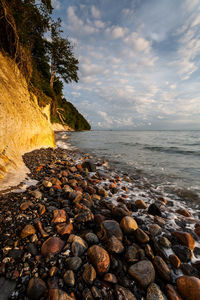 Pebbles on beach against sky