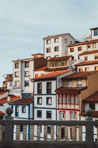 Low angle view of buildings in town against sky