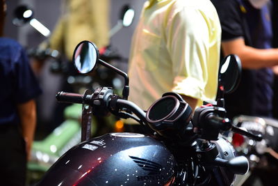 Rear view of man riding motor scooter on street