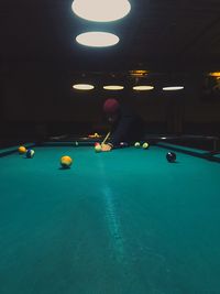 Man playing with ball in pool