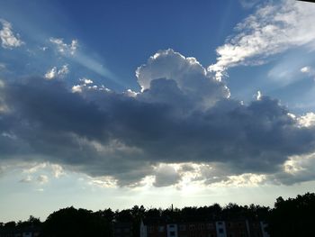 Low angle view of silhouette trees against sky