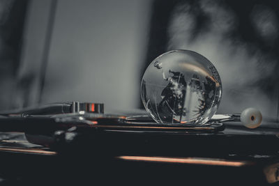 Close-up of crystal ball on glass table