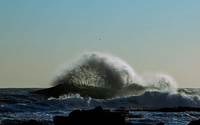 Close-up of sea waves against clear sky