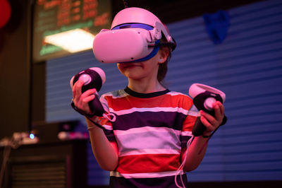 Vr game and virtual reality. kid boy gamer six years old fun playing on futuristic video game