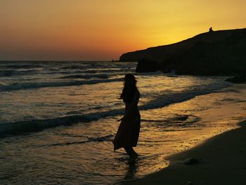 Woman on beach during sunset