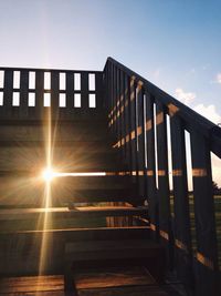 Low angle view of sun shining through clouds