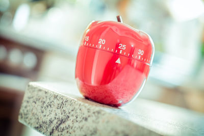 Close-up of apple shape dial on table