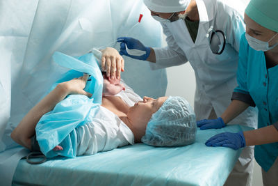 Midsection of doctor examining patient in hospital