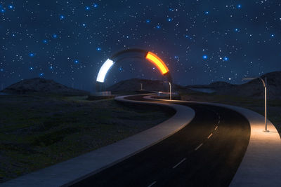 Cars on illuminated road against sky at night