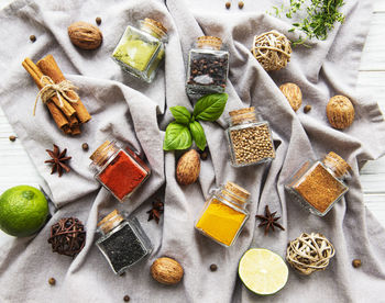 Jars with dried herbs, spices on the table