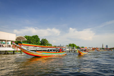 Boats moored in sea against sky