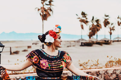 Full length of woman at beach against sky