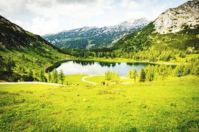 Scenic view of lake and mountains against sky