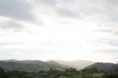 Scenic view of mountains against cloudy sky