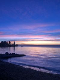 Scenic view of sea against romantic sky at sunset