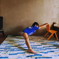 Full length of man standing against wall