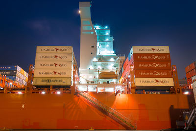 Low angle view of illuminated buildings against sky at night