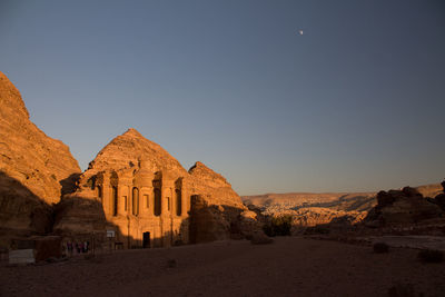 Scenic view of al deir monastery struck by the golden sunset, at the top of the city of petra.