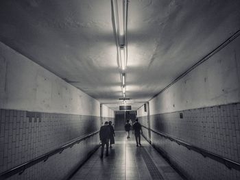 Rear view of man walking in tunnel