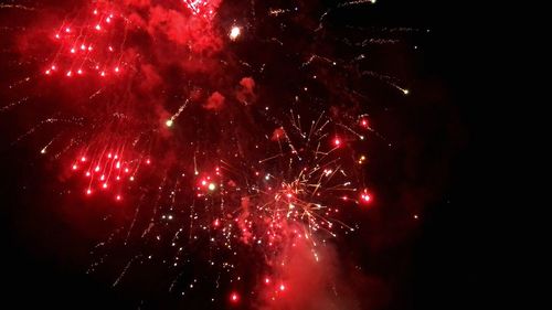 Low angle view of firework display at night