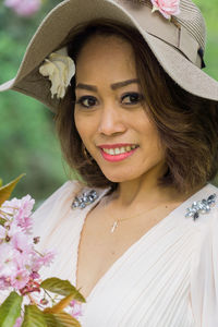 Portrait of smiling young woman wearing hat