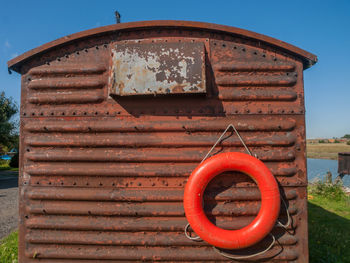 Red inflatable ring on rusty built structure