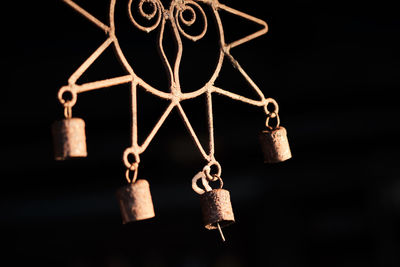 Close-up of decoration hanging against black background