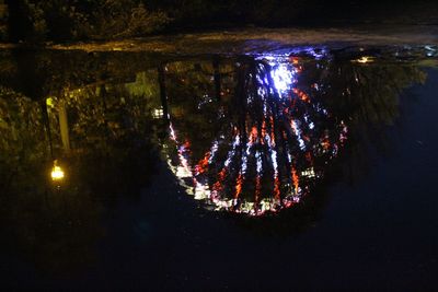 Reflection of illuminated sky in water at night