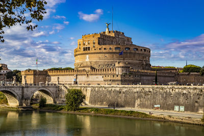 Arch bridge over river against sky