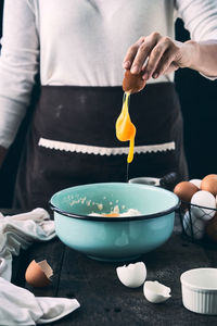 Midsection of man preparing food on table