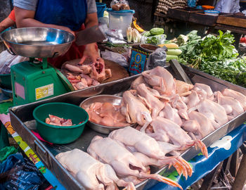 Midsection of man fish at market stall