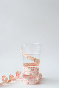 Close-up of glass on table against white background