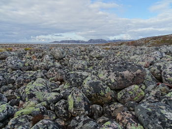 Aerial view of rocks on land against sky