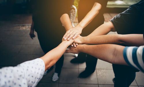 High angle view of friends stacking hands