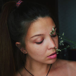 Close-up of young woman with flower 