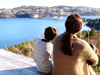 Rear view of people looking at sea