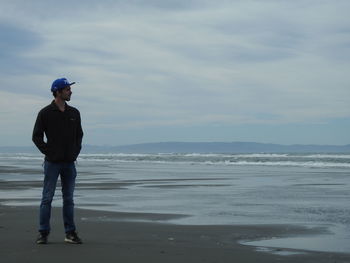 Full length of man on beach against sky