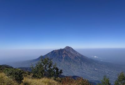 Scenic view of mountains against clear blue sky