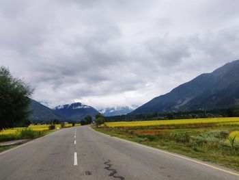Empty road along countryside landscape
