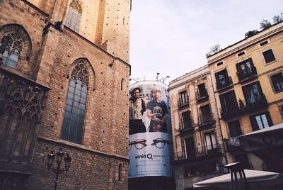 Low angle view of statue against buildings in city