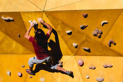 Rear view of woman on climbing wall