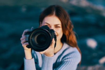 Portrait of woman photographing