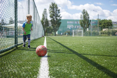 Man playing soccer ball on field