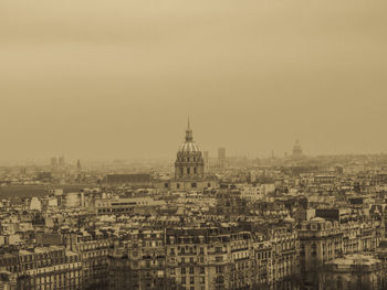 Buildings in city against clear sky